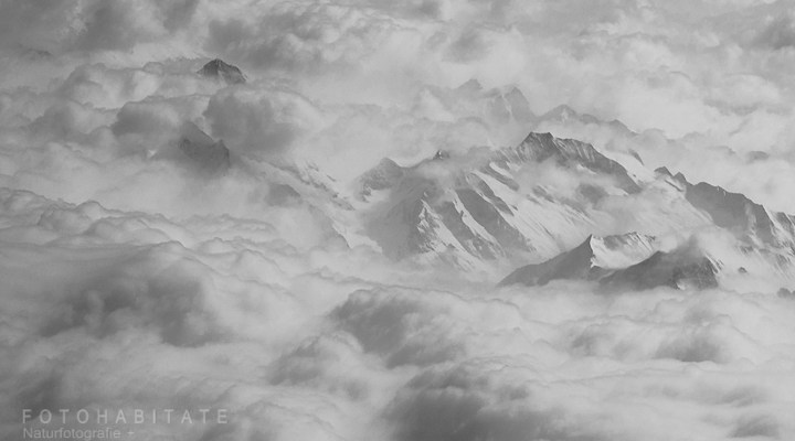 Bergspitzen im grauen Wolkenmeer
