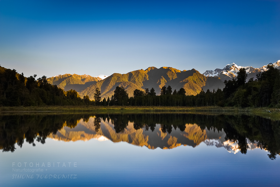 Berge spiegeln sich im blauem See