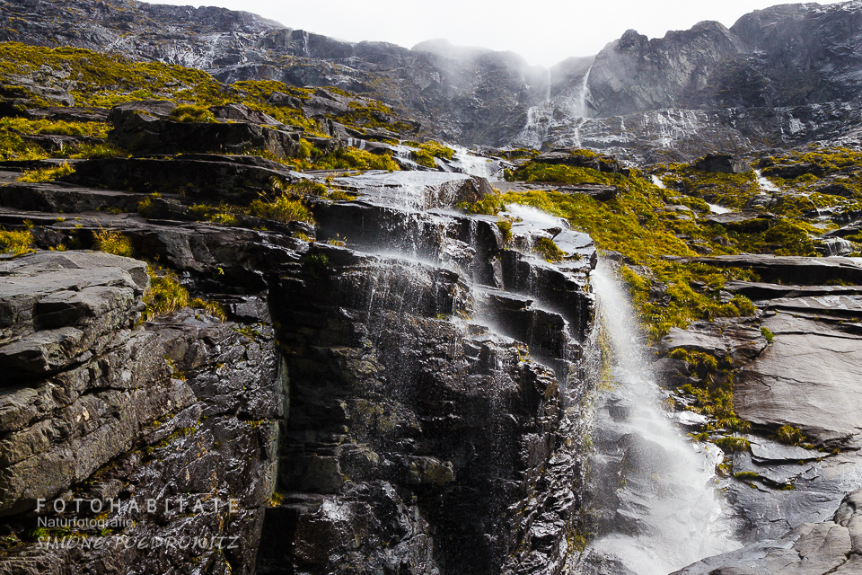 zahlreiche Wasserfälle fließen schwarze Felsen hinunter
